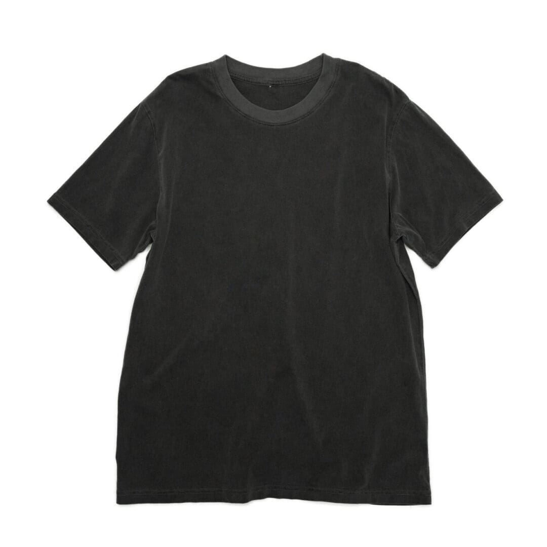 A black t-shirt is shown on the ground.